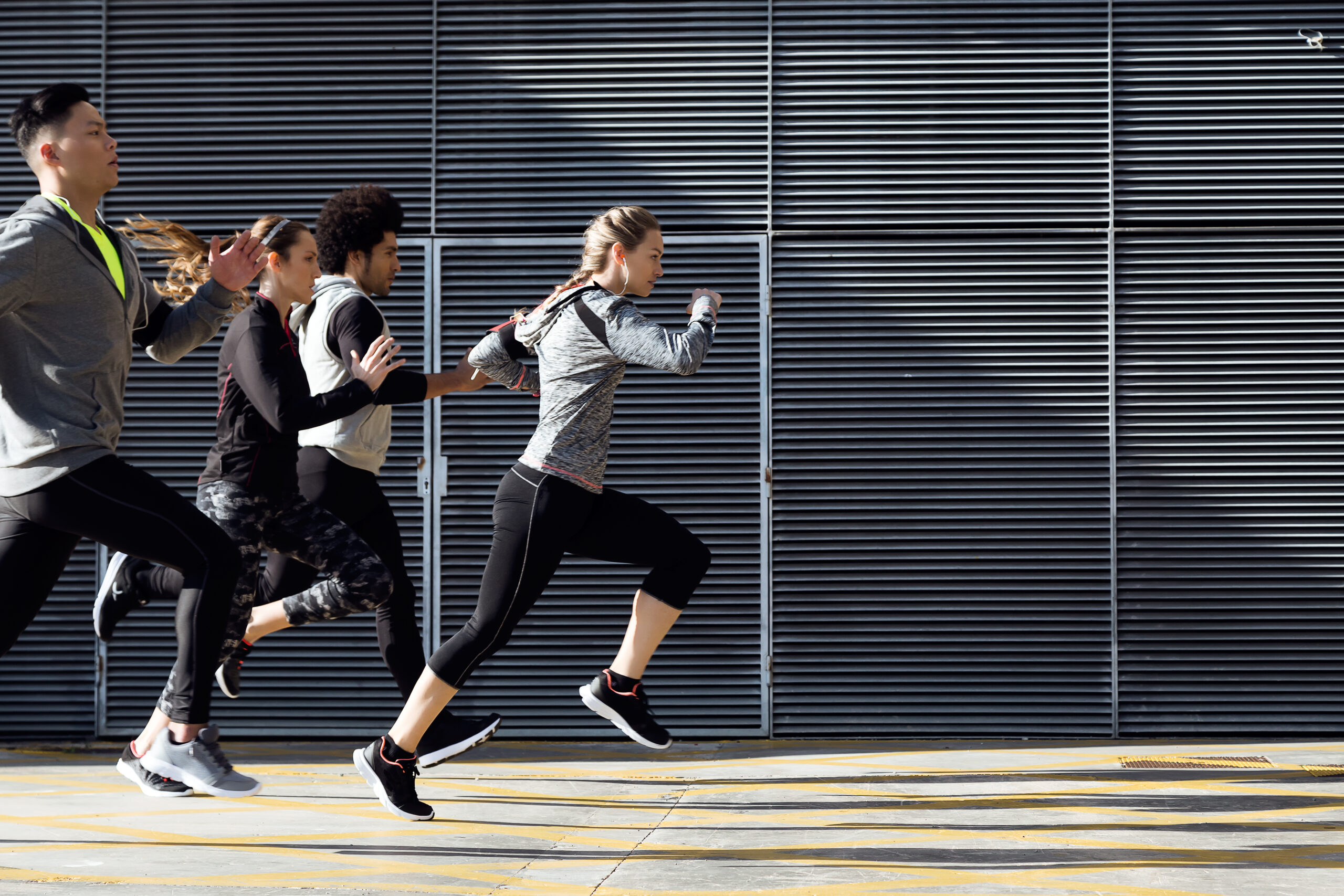 Outdoor,Portrait,Of,Group,Of,Friends,Running,In,The,City.